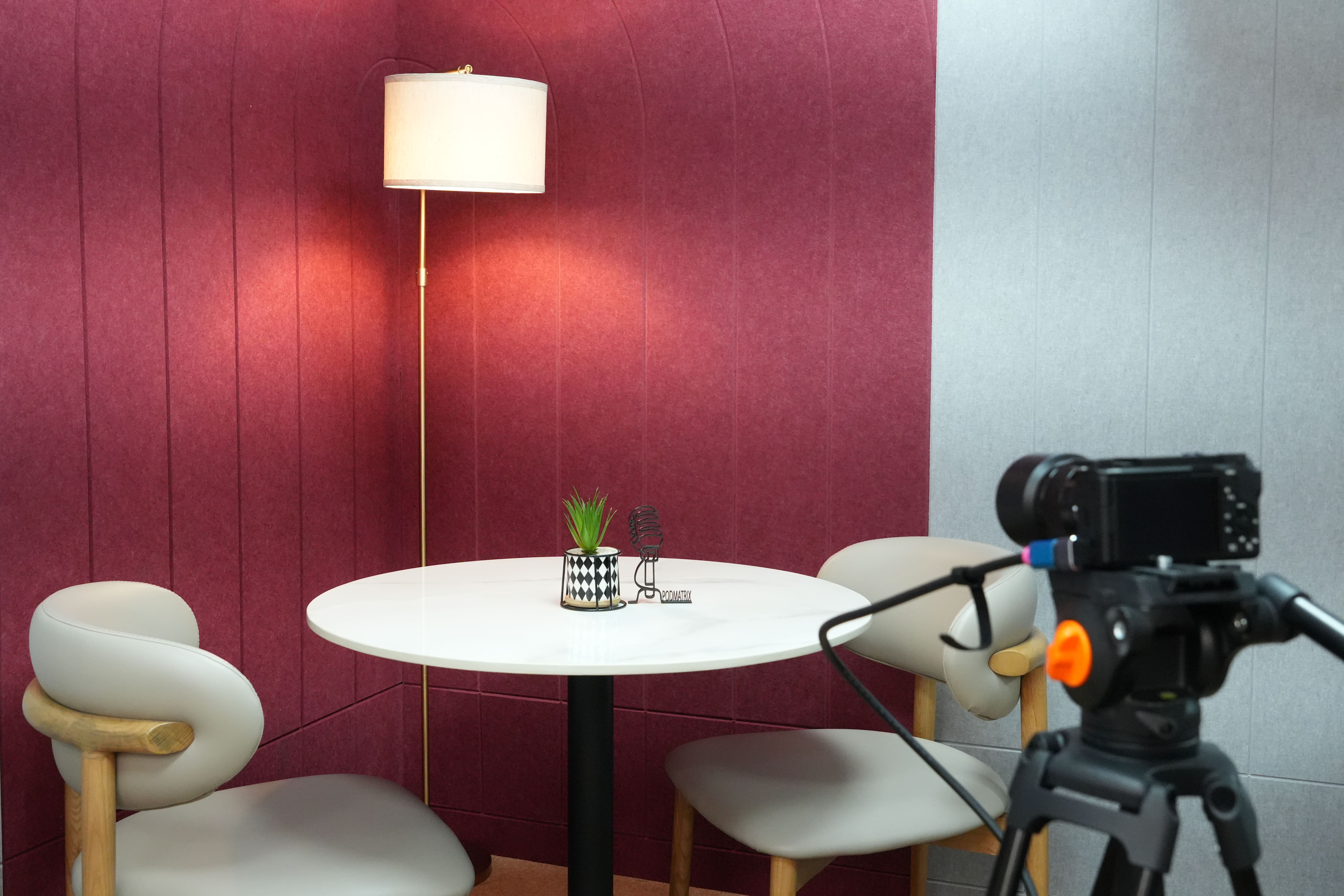 Wide-angle view of Podmatrix Studio's podcast recording space with modern decor